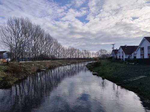 a river with houses on the side of it at Villa de Calma Samorin in Šamorín