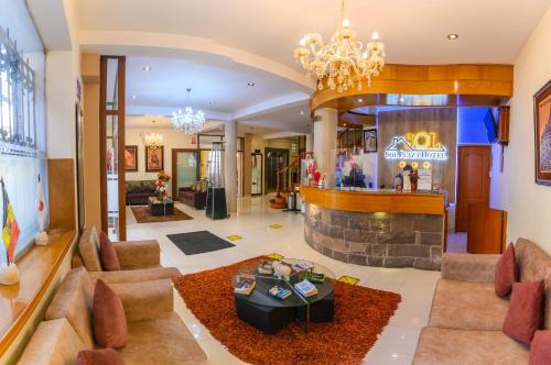 a living room with a chandelier and a fireplace at Sol Plaza Hotel in Puno