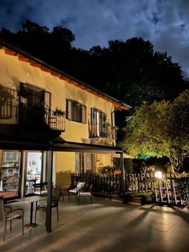 a building with tables and chairs in front of it at B&B La Lanterna in Verbania