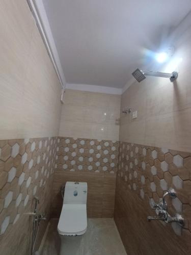 a bathroom with a white toilet and a shower at Kadamba Bnb Homestay in Kurseong