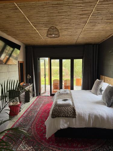 a bedroom with a large bed in a room with sliding glass doors at Glorious Stay in Porterville