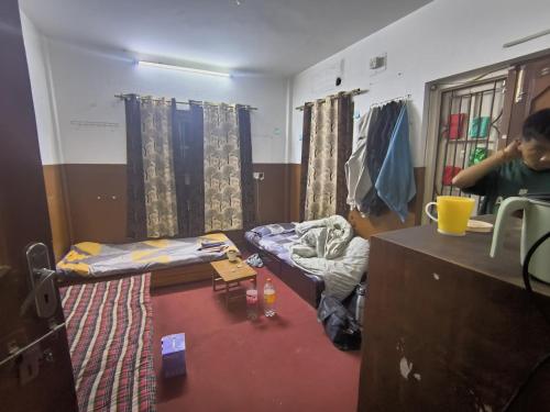 a room with a room with a bed and a desk at Amazon Boys Hostel in Kathmandu