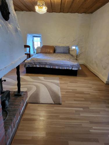 a bedroom with a bed and a wooden floor at Torseke Hostel in Kristianstad