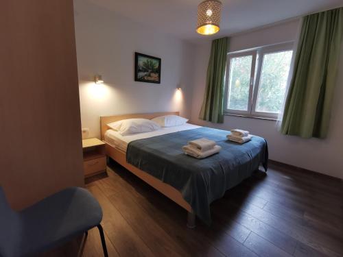 a bedroom with a bed with two towels on it at Apartman Magdalena in Cres