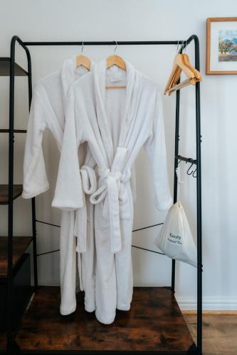 a white robe hanging on a rack at Le Petit Paris in Franschhoek