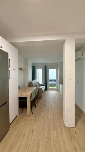 a large living room with a table and a couch at Azahar Home Sevilla in Seville
