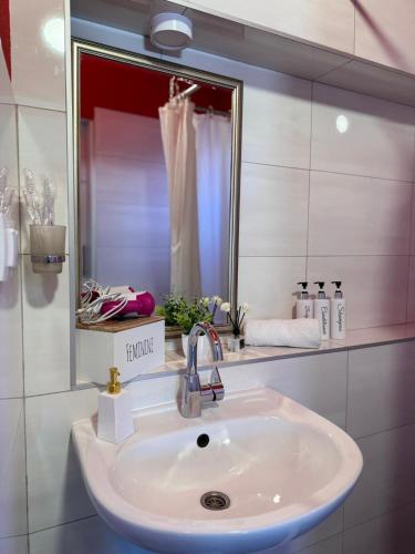 a bathroom with a sink and a mirror at Central Stay Mostar - Apartments & Rooms in Mostar