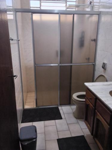 a bathroom with a shower stall and a toilet at Hostel caminho da Serra in São Pedro