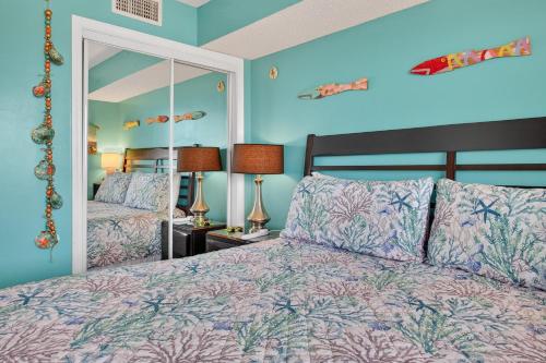 a bedroom with a bed and a large mirror at 6405 Gulf Shores Plantation-Palms in Gulf Shores