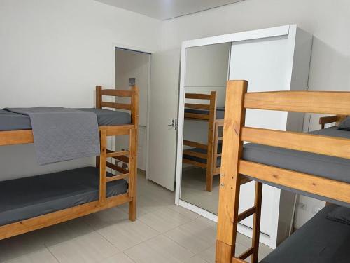 a room with two bunk beds and a mirror at Casa para 8 pessoas in Itu