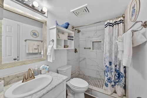 a white bathroom with a sink and a toilet at 6405 Gulf Shores Plantation-Palms in Gulf Shores