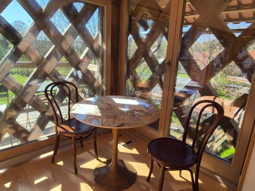 a table and chairs in a room with a large window at Cosy Village in Šentjernej