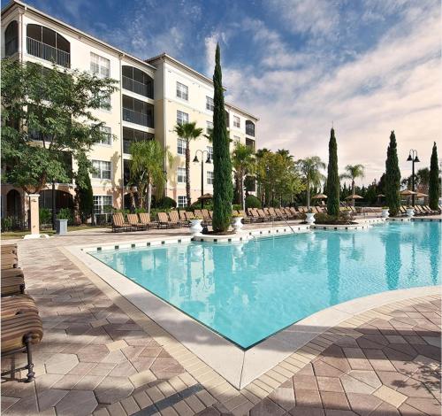 a large swimming pool in front of a building at Spacious 3 Bed 3 Bath Luxury Condo 5 min from Disney in Orlando