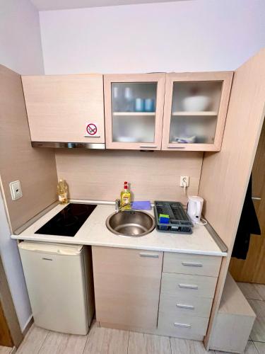 a small kitchen with a sink and a counter top at Polo Resort studio in Sunny Beach