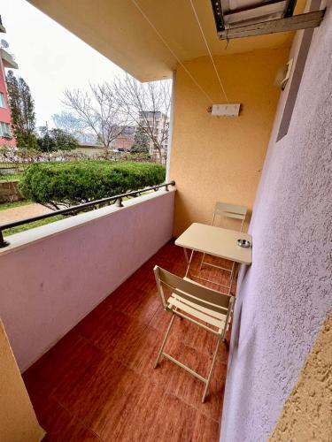 a small balcony with a table and two chairs at Polo Resort studio in Sunny Beach