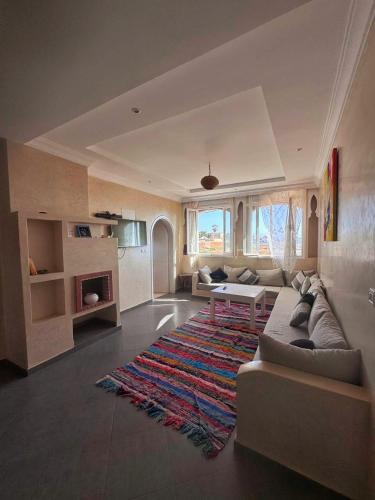 a living room with a couch and a rug at Mirleft Horizon Apartments in Mirleft