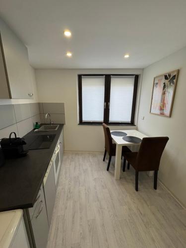 a kitchen with a table and chairs and a dining room at Bella Vita Apartment due in Ediger-Eller