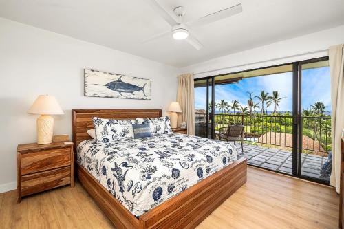 a bedroom with a bed and a balcony at Keauhou Punahele#B-207 in Kailua-Kona
