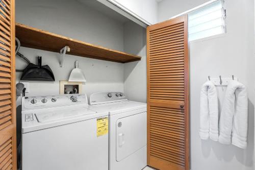 a kitchen with a stove and a washer and dryer at Keauhou Punahele#B-207 in Kailua-Kona