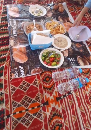 a table topped with plates of food on top at Royal Felucca - Shared Amazing Sailing in Aswan
