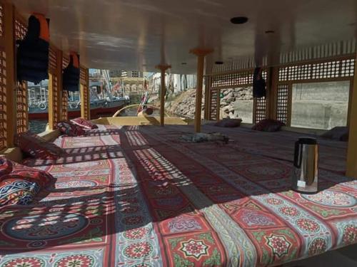a group of four beds in a room at Royal Felucca - Shared Amazing Sailing in Aswan