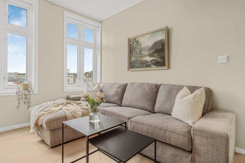 a living room with a couch and a table at Contemporary city-apartement with views of the dock! in Bergen
