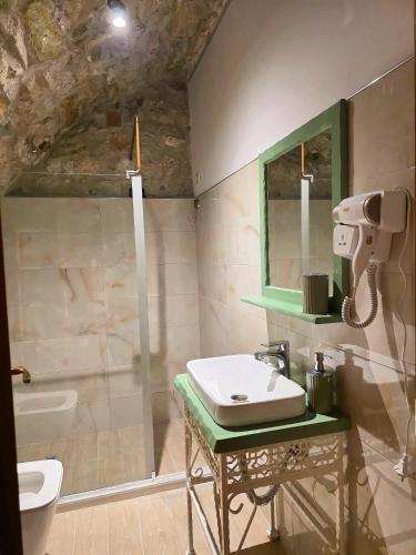 a bathroom with a sink and a mirror at Jeanette's Home in Berat