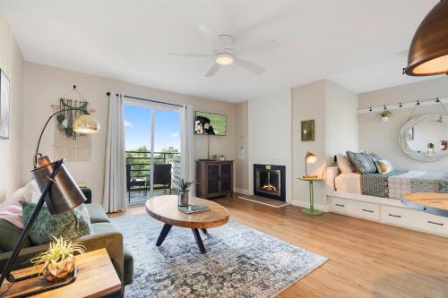 a living room with a bed and a fireplace at Above the Trees - Modern Studio for 2 with Views, Wifi, Pools in Gatlinburg