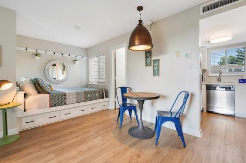 a bedroom with a bed and a table and chairs at Above the Trees - Modern Studio for 2 with Views, Wifi, Pools in Gatlinburg