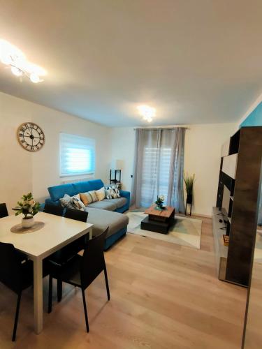 a living room with a blue couch and a table at Dimora di Teglio in Teglio