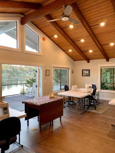 a room with tables and chairs and a large window at The Riptide Retreat in Shelton