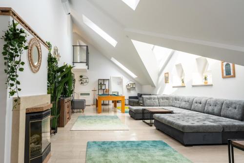 a living room with couches and a fireplace at Sky Garden Vienna in Vienna