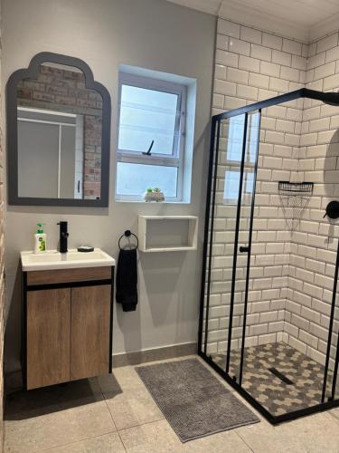 a bathroom with a shower and a sink at Prospect Cottage in Walmer