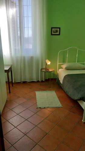 a bedroom with a bed and a lamp on a tiled floor at Tenuta Rio del Sole-Camera singola in Albairate