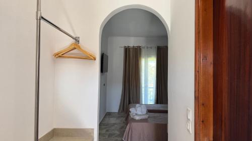 a hallway with an archway leading to a bedroom at Marili Apartments in Roda