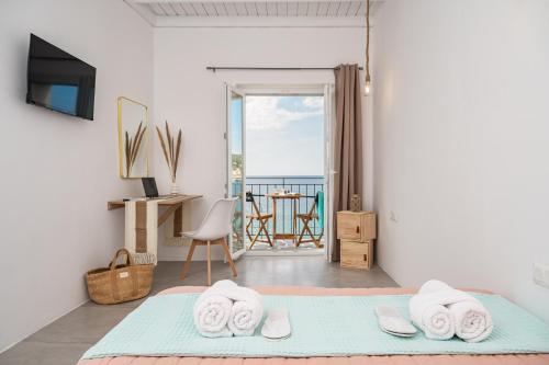 a bedroom with a bed and a view of the ocean at SeaView City in Samos