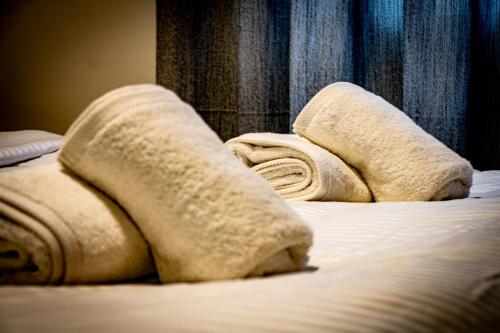 a bed with two towels on top of it at Marathon Coastal House in Marathon