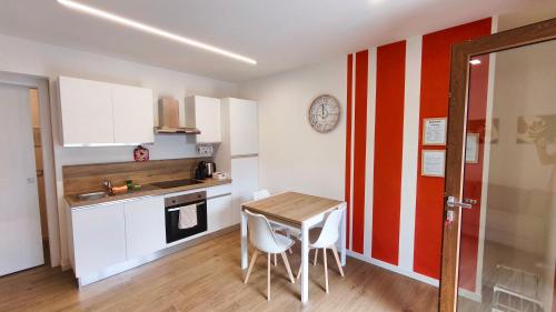 a kitchen with a table and chairs in a room at San Martì Casa Vacanze in Piazza Brembana