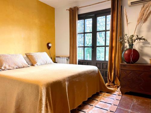 a bedroom with a bed and a large window at Boutique Finca Stay in Nature in Mijas