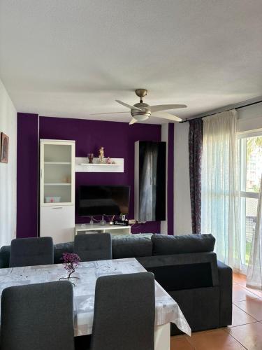 a living room with a couch and a ceiling fan at Los Lentiscares Apartment in Torrox Costa