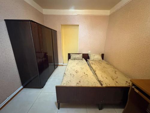 a bedroom with a bed in the corner of a room at Hotel MANTASHOV in Meghri