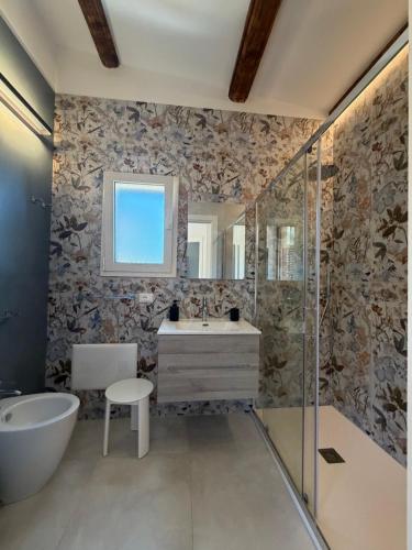 a bathroom with a tub and a sink and a bath tub at Scopello Guidaloca Villas in Scopello