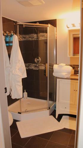 a shower with a glass enclosure in a bathroom at Nestled Inn Bed and Breakfast in Victoria
