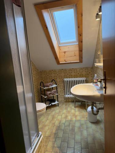 a bathroom with a sink and a toilet and a window at Ferienhaus Spornitz in Mittenwald