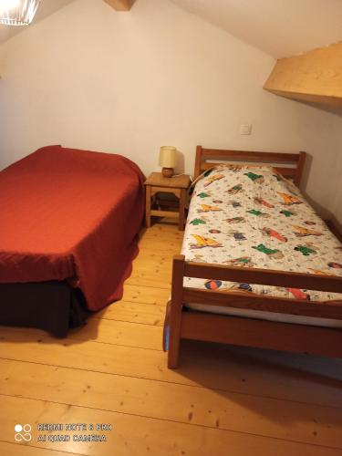 a small bedroom with a bed and a night stand at Gite à Valleraugue Gard Cevennes in Valleraugue