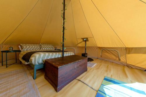 a room with a bed in a tent at Furnished Bell Tent 1 in St Austell
