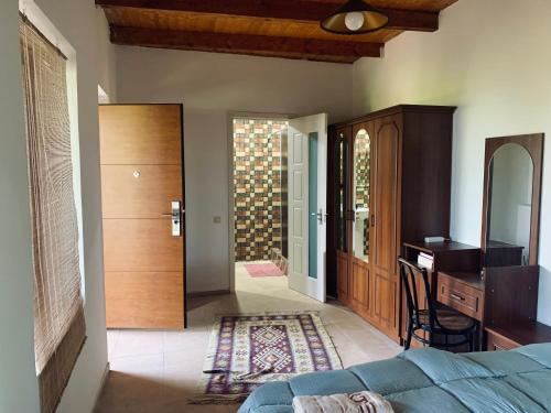 a bedroom with a bed and a desk and a mirror at Nukriani Keiptauni Residence in Sighnaghi