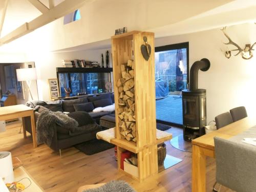 a living room with a wood stove in a room at Ferienhaus Allrode mit Wellness in Allrode