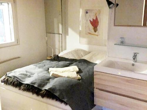 a small bedroom with a bed and a sink at Ferienhaus Allrode mit Wellness in Allrode