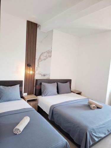 two beds sitting next to each other in a room at Apartments Perezaj II in Ulcinj